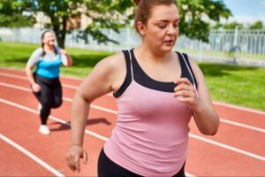Woman exercising outdoors to support metabolic health during midlife and reduce risk of metabolic syndrome.