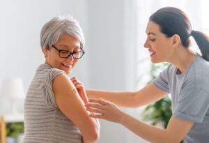 Midlife woman receiving care, representing immune system changes and autoimmune risk during menopause.